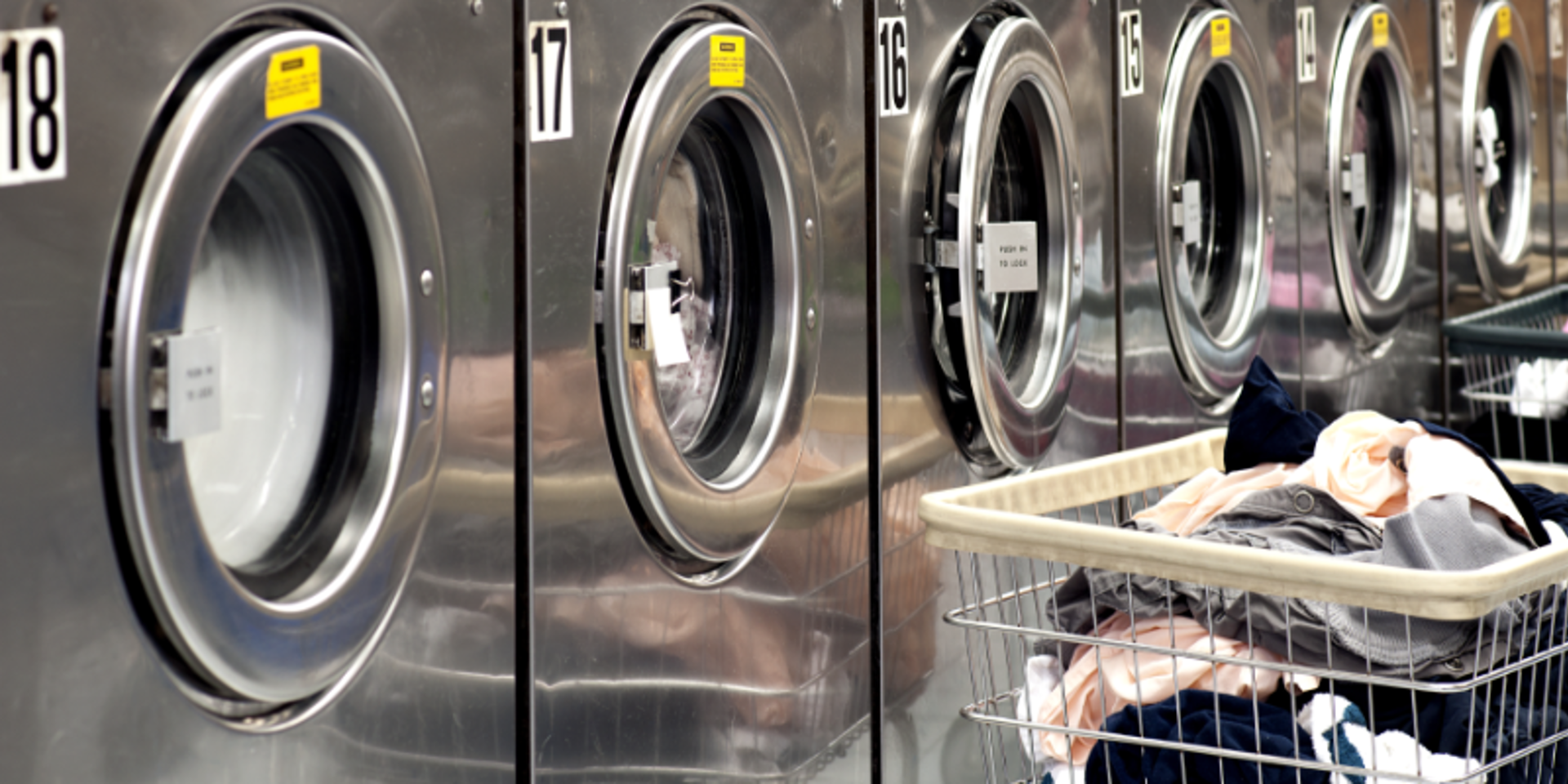 Row Of Washers With Cart Of Clothes